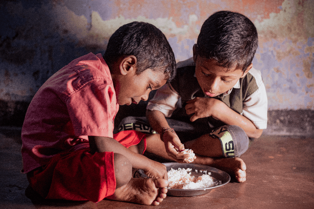 Vengadeshwaram and Vishal are sitting on the floor in their home eating their lunch, a bowl of rice.