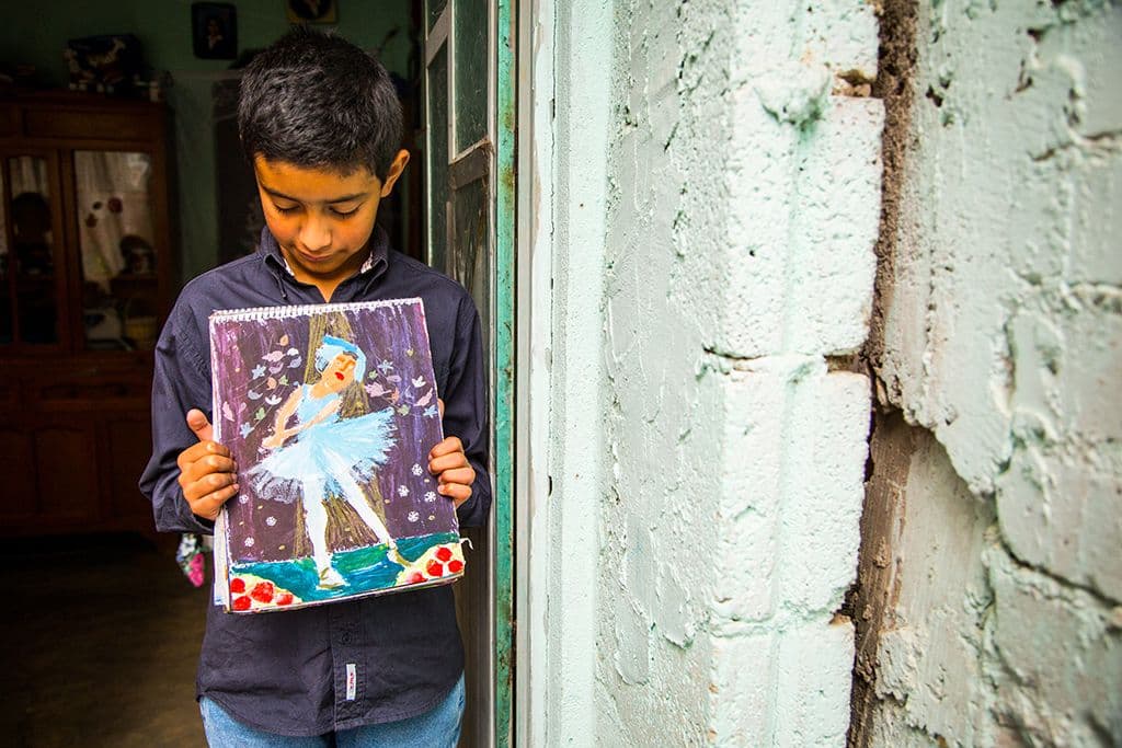 boy holding his painting