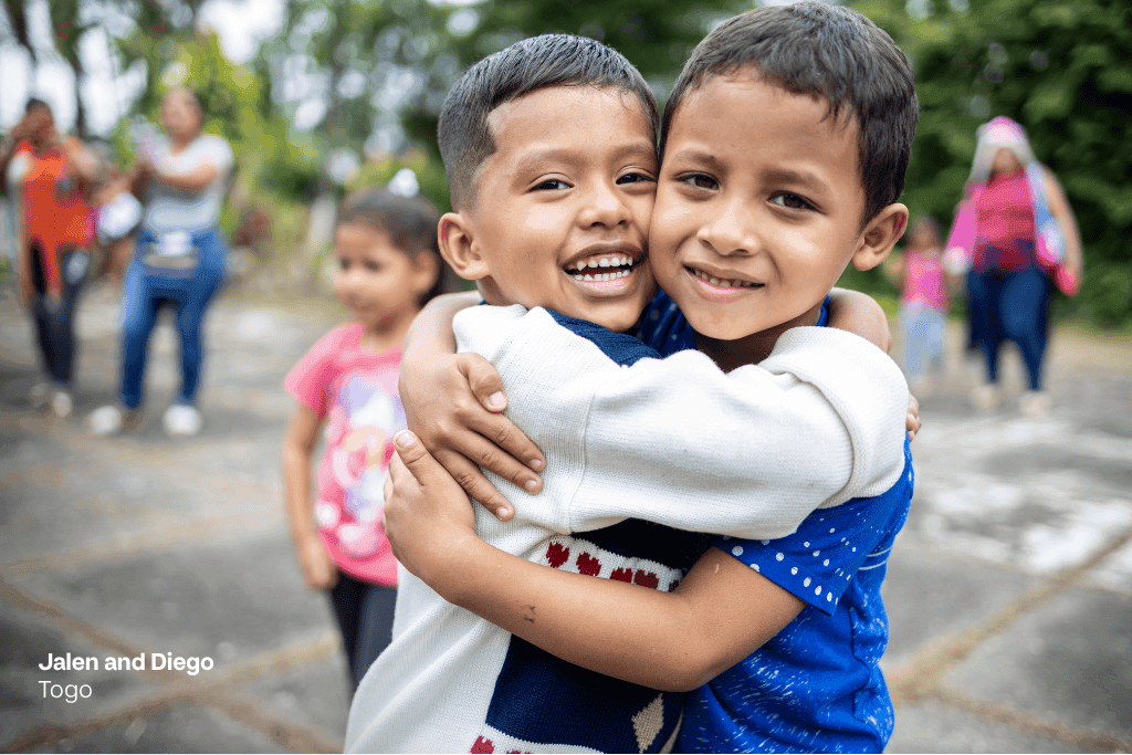 Jalen and Diego from Togo hug each other