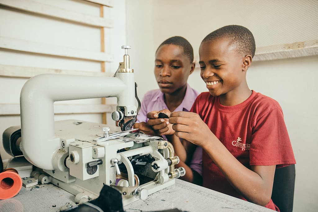 Twin boys making shoes