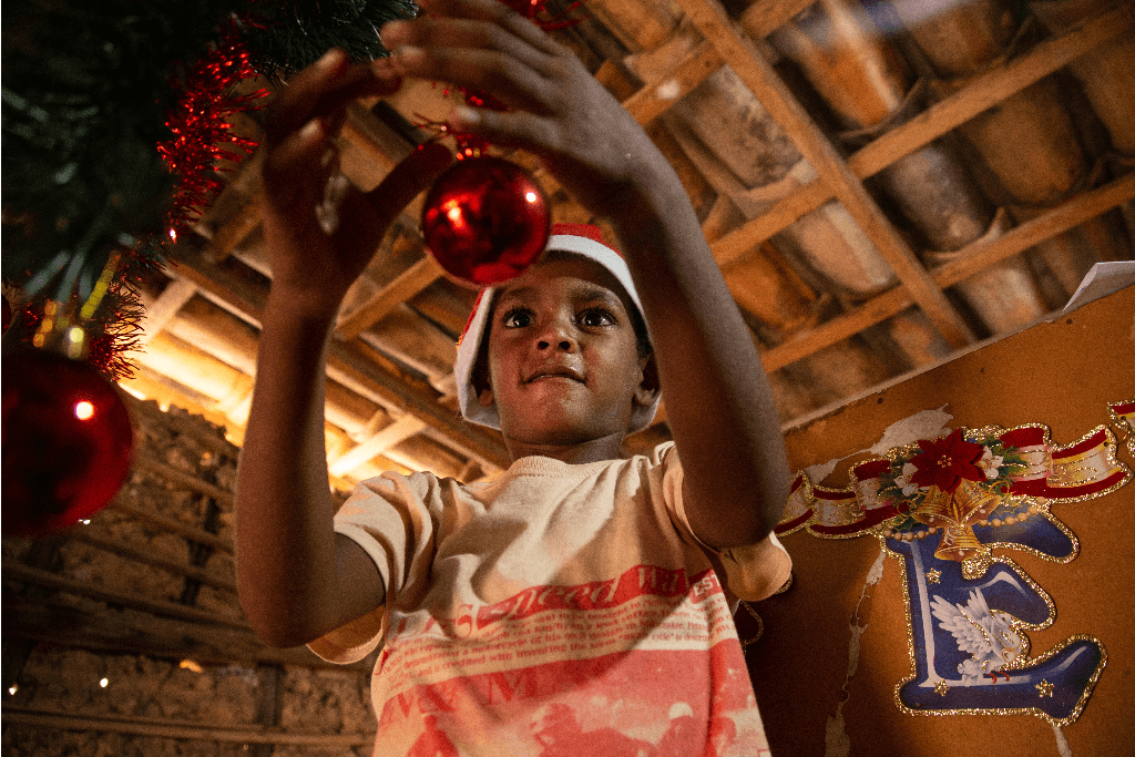 Marcos is putting up decorations around his home.