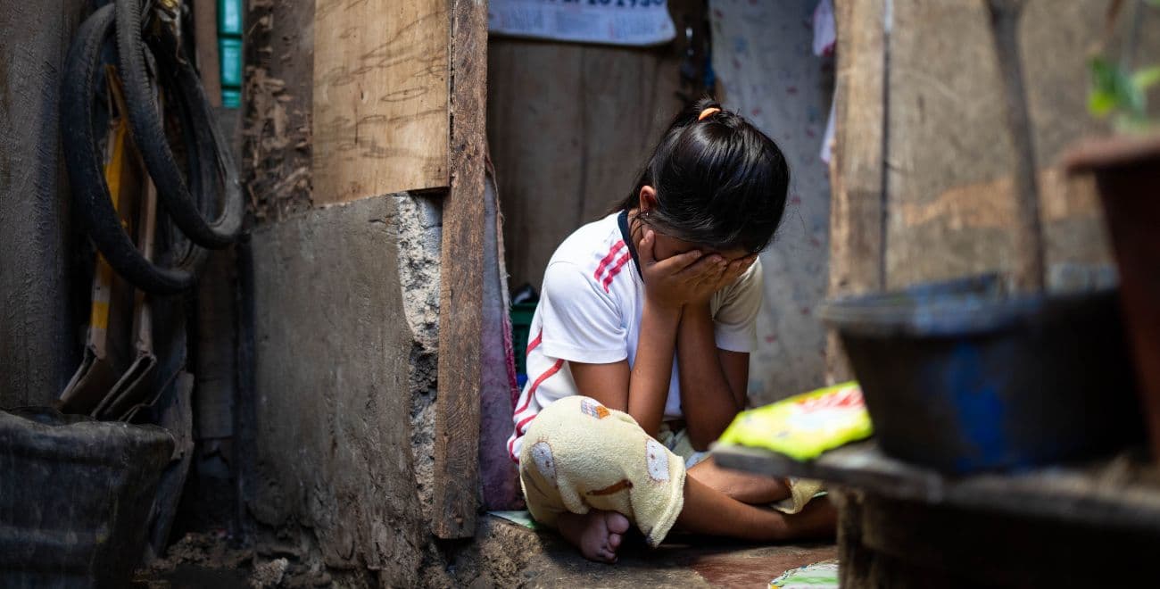 Girl with face in hands