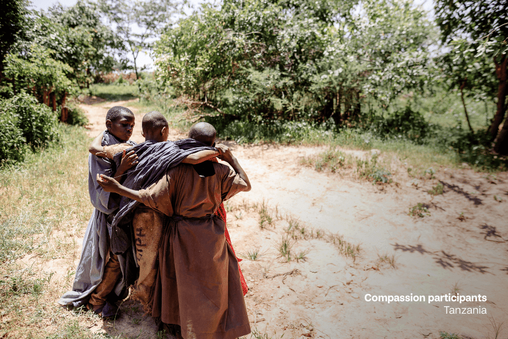 Compassion participants in Tanzania re-enact the Good Samaritan caring for the man on the road.