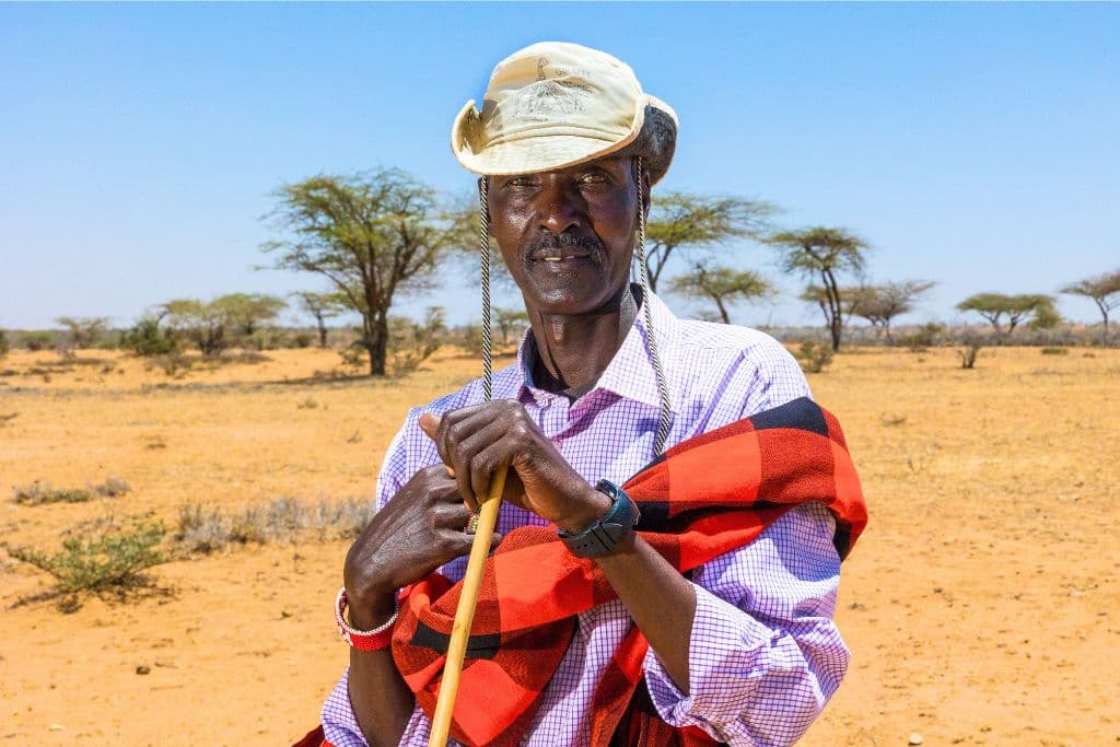 Joseph standing near his house