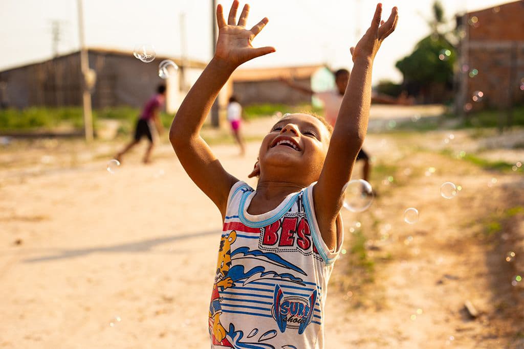 Brazilian boy playing bubbles