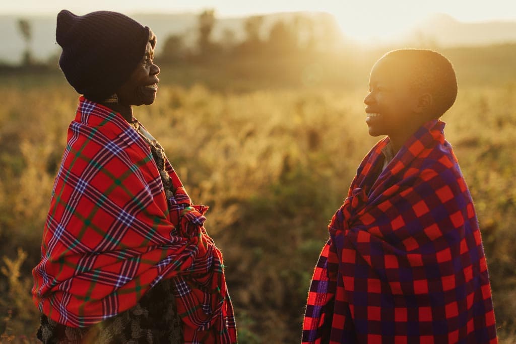 Collins and his grandmother in a sunlit field