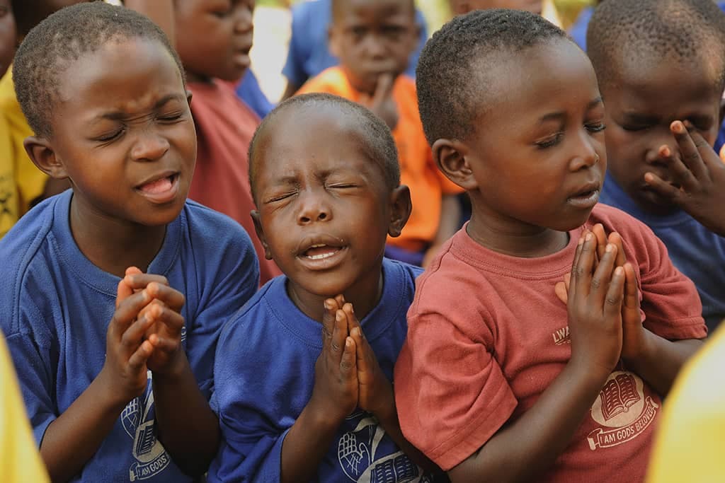 A group of boys praying