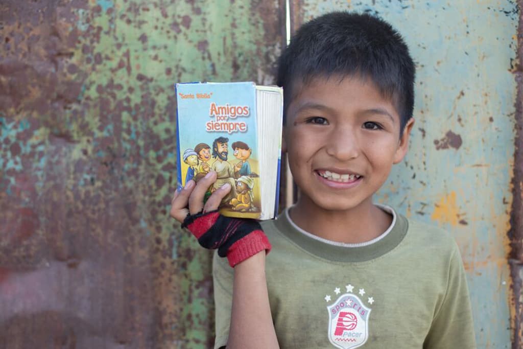 Elvis from Bolivia proudly holding his Bible.