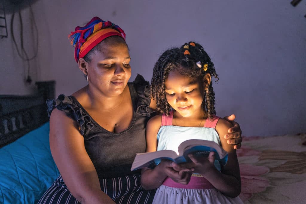 Girl and mother read the Bible