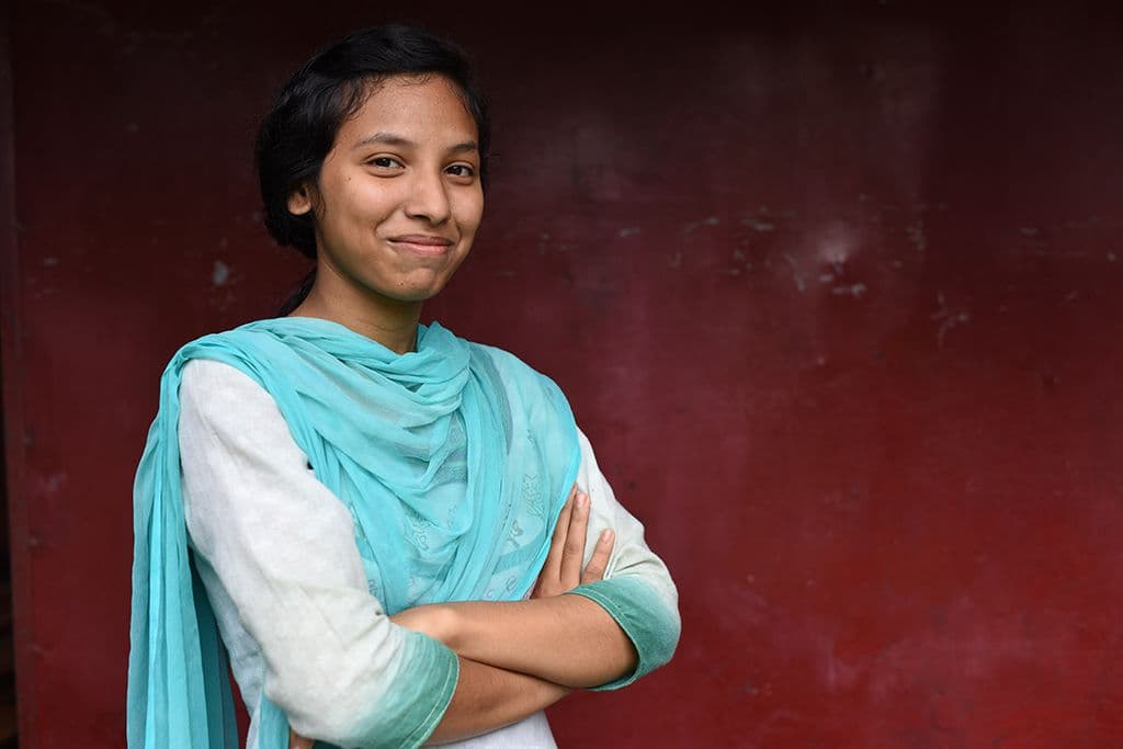 a young girl dressed in blue
